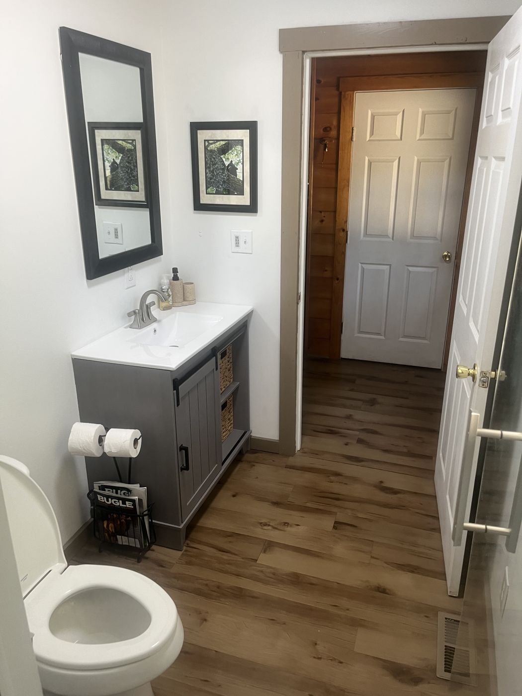 Bathroom vanity and sink, looking out to the hallway