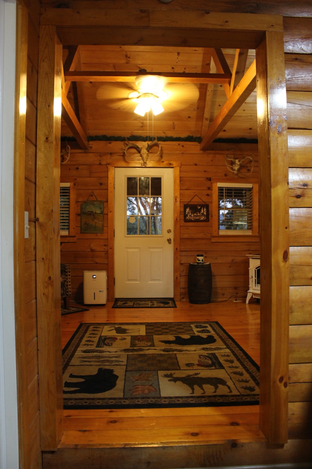 Entry room with pellet stove and timber-frame ceiling